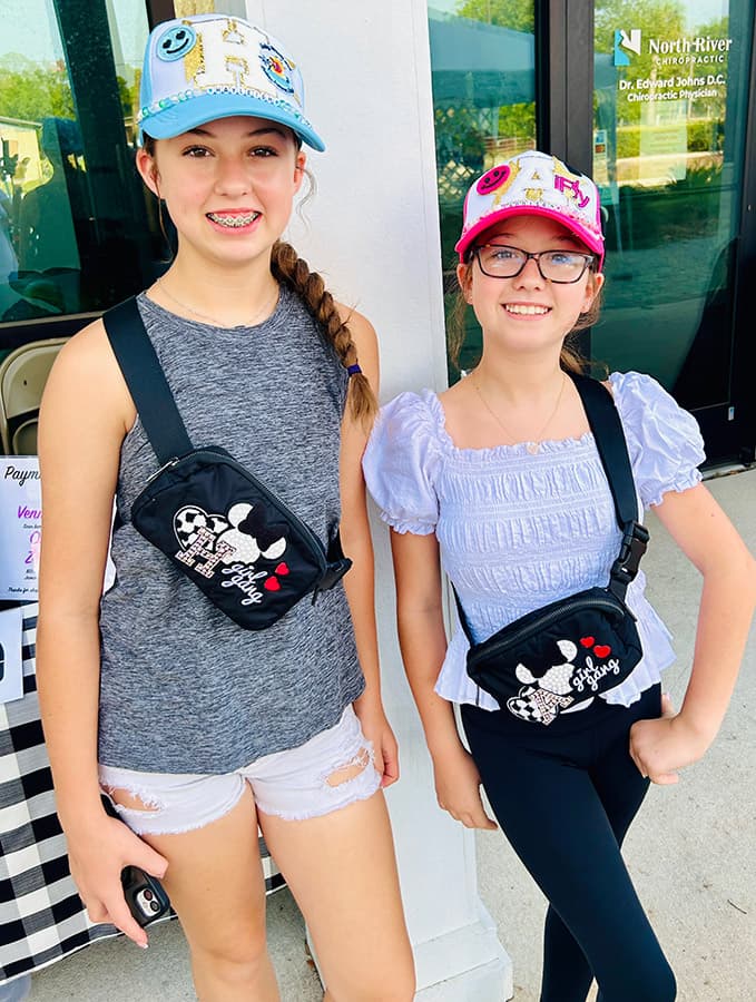 girls wearing hats and belt bags